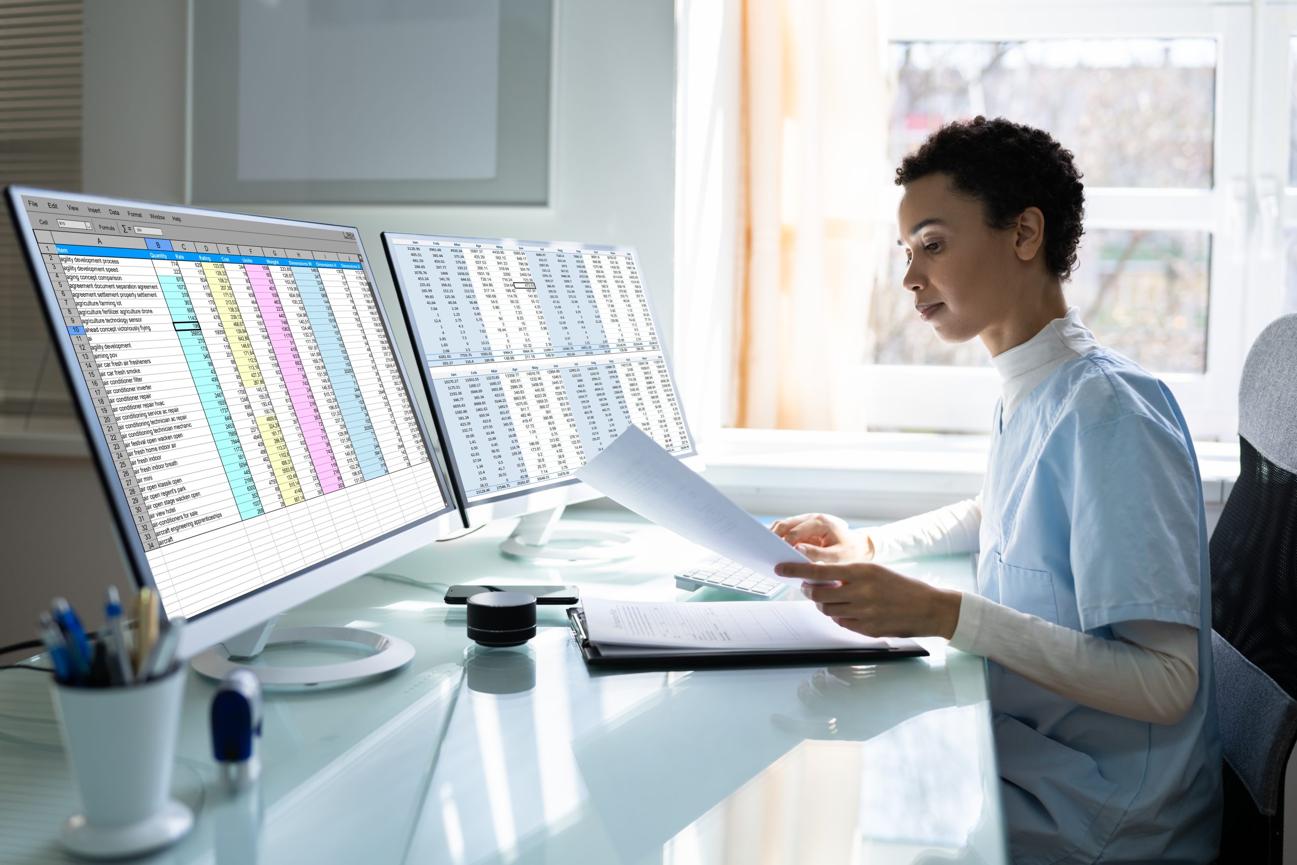 Woman looking through paperwork and spreadsheets